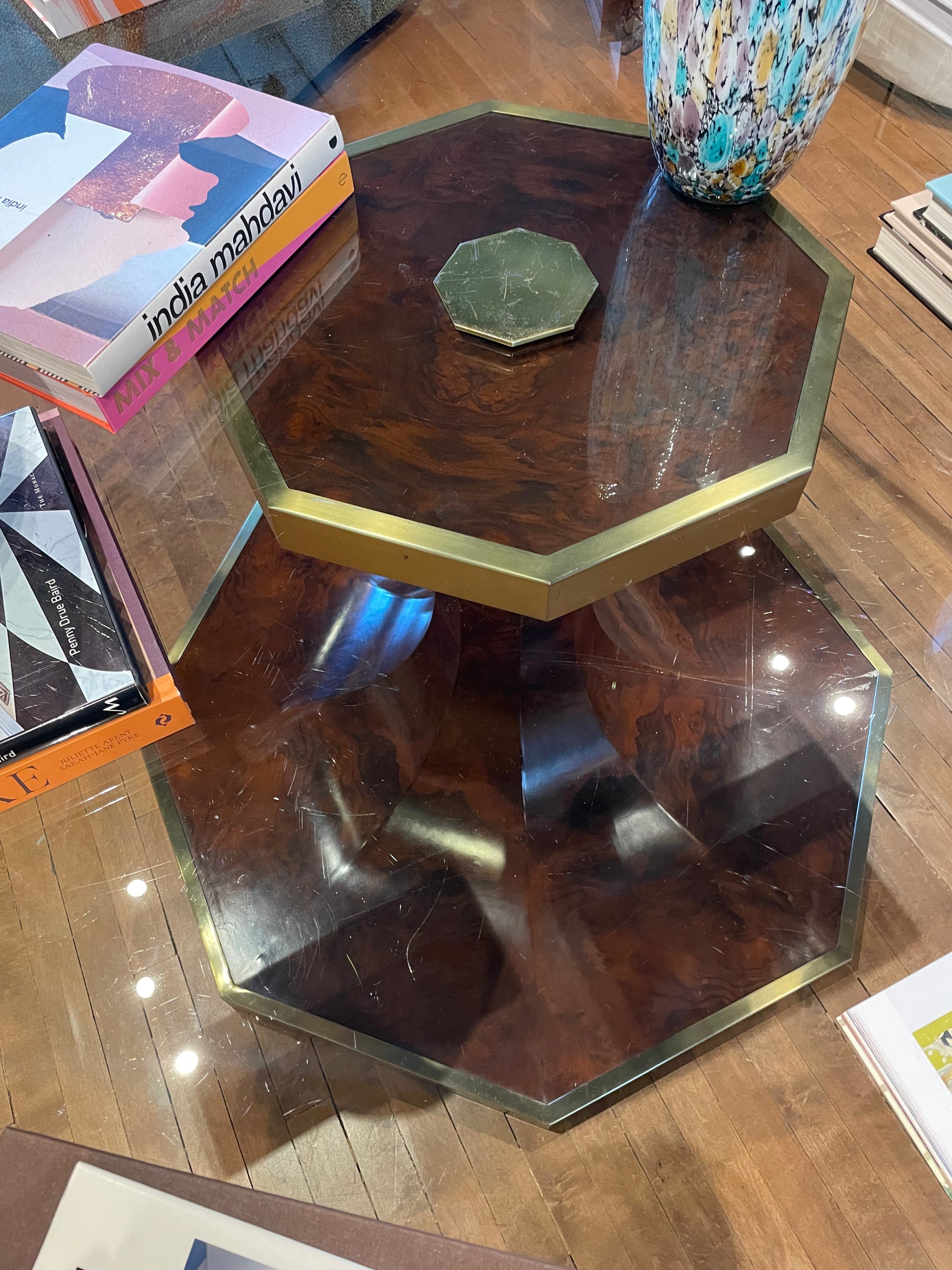 Vintage brass tulip table with a glass top, featuring a sleek, modern design and elegant brass base by The Vault Creative.