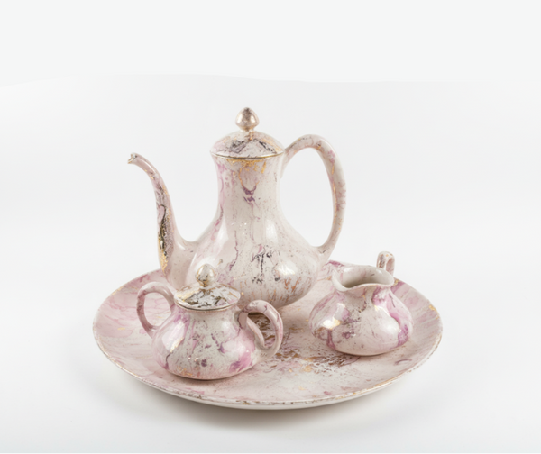Sascha Brastoff tea set featuring colorful ceramic teapot, cups, and saucers with vibrant, vintage-inspired designs.