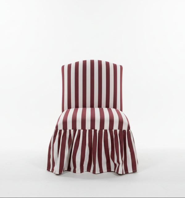 Pink and fuchsia striped fabric chair with a skirt, designed by The Vault Creative, showcasing stylish and vibrant home seating.