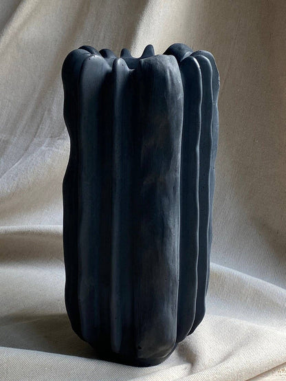 Forma concrete vase by Atelier La Rouleuse with a smooth, minimalist design and neutral gray finish on a plain background.