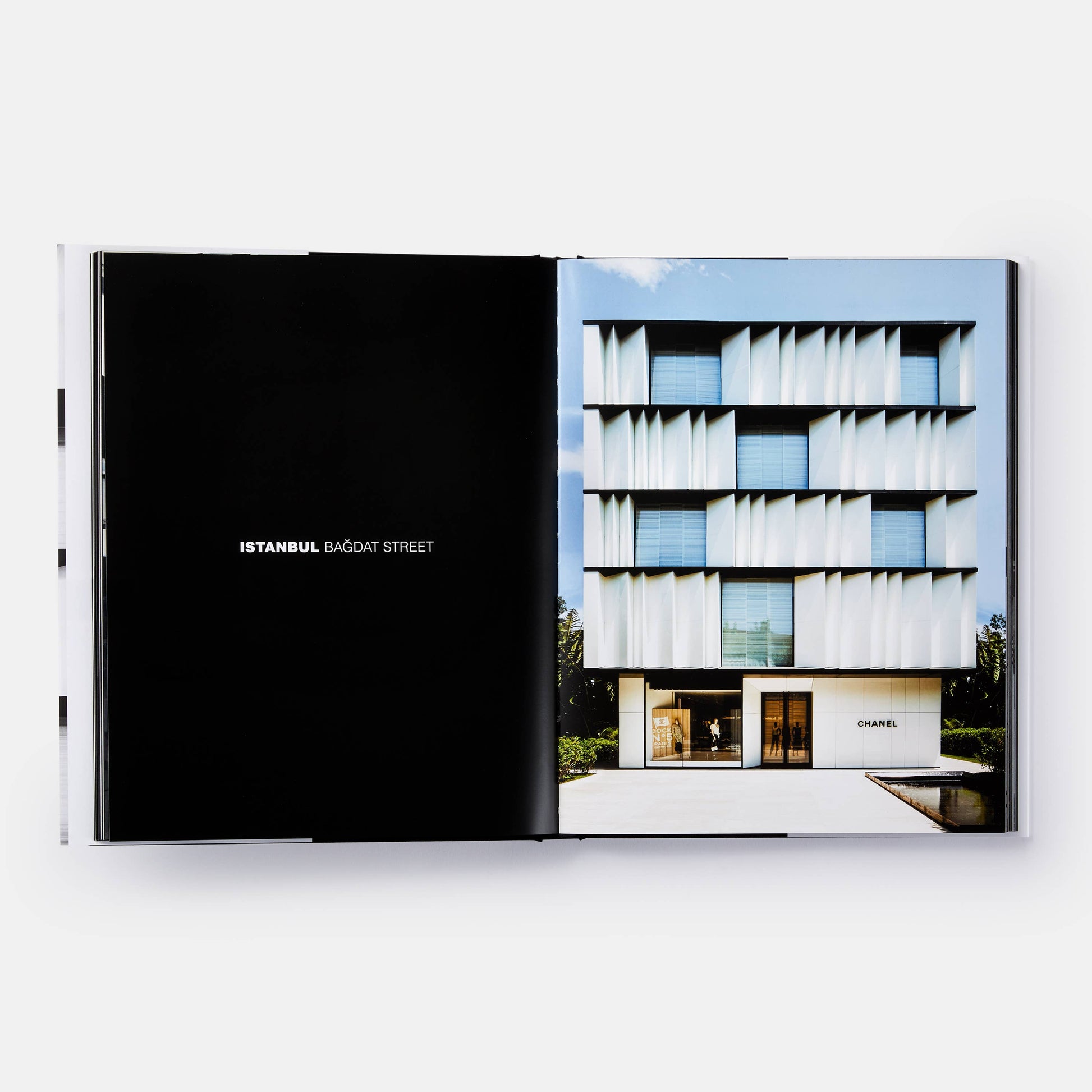 Cover of "The Architecture of Chanel" book by Phaidon featuring a Chanel building design in gold and black.