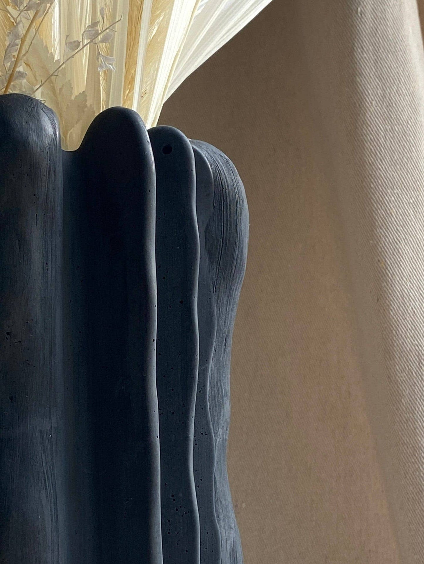 Concrete vase by Atelier La Rouleuse with a modern, minimalist design, showcasing a smooth, neutral-toned surface.