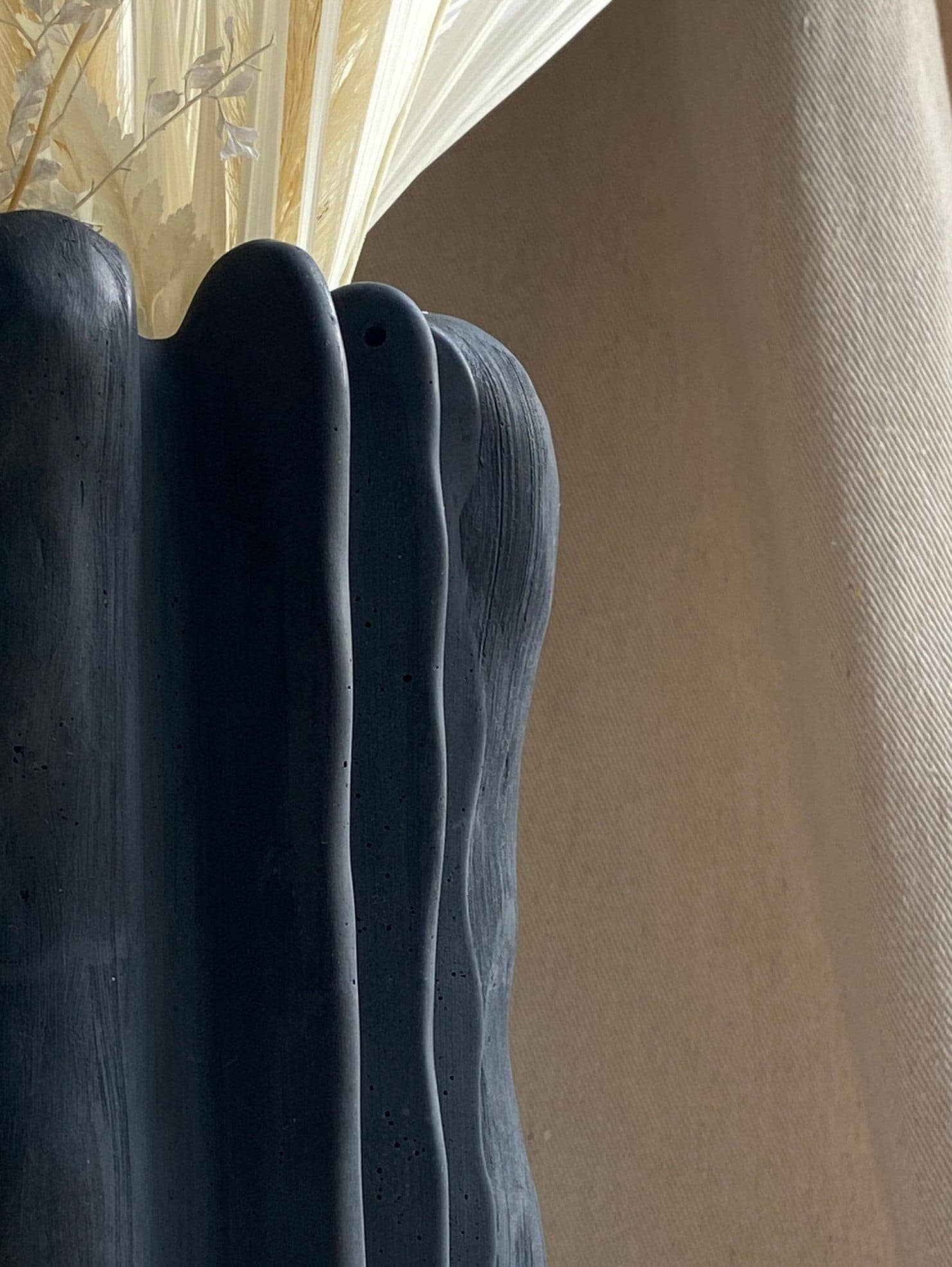 Concrete vase by Atelier La Rouleuse with a modern, minimalist design, showcasing a smooth, neutral-toned surface.