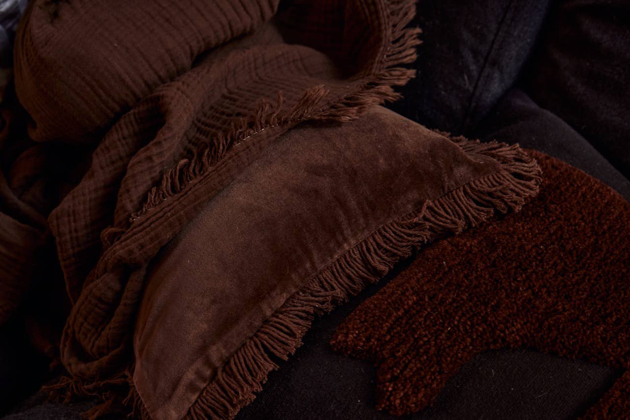 Black and chocolate abstract cushions by Saardé with modern geometric patterns and soft fabric textures.