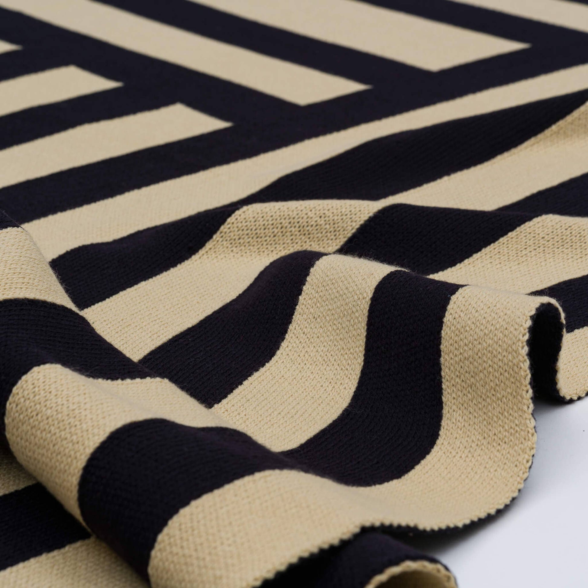 VERLOOP Columns Throw blanket with a woven knit pattern, featuring neutral tones and textured fabric for cozy home decor.