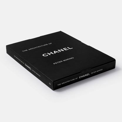 Open book titled "The Architecture of Chanel" by Phaidon, showing detailed black and white photographs of Chanel's architectural designs.