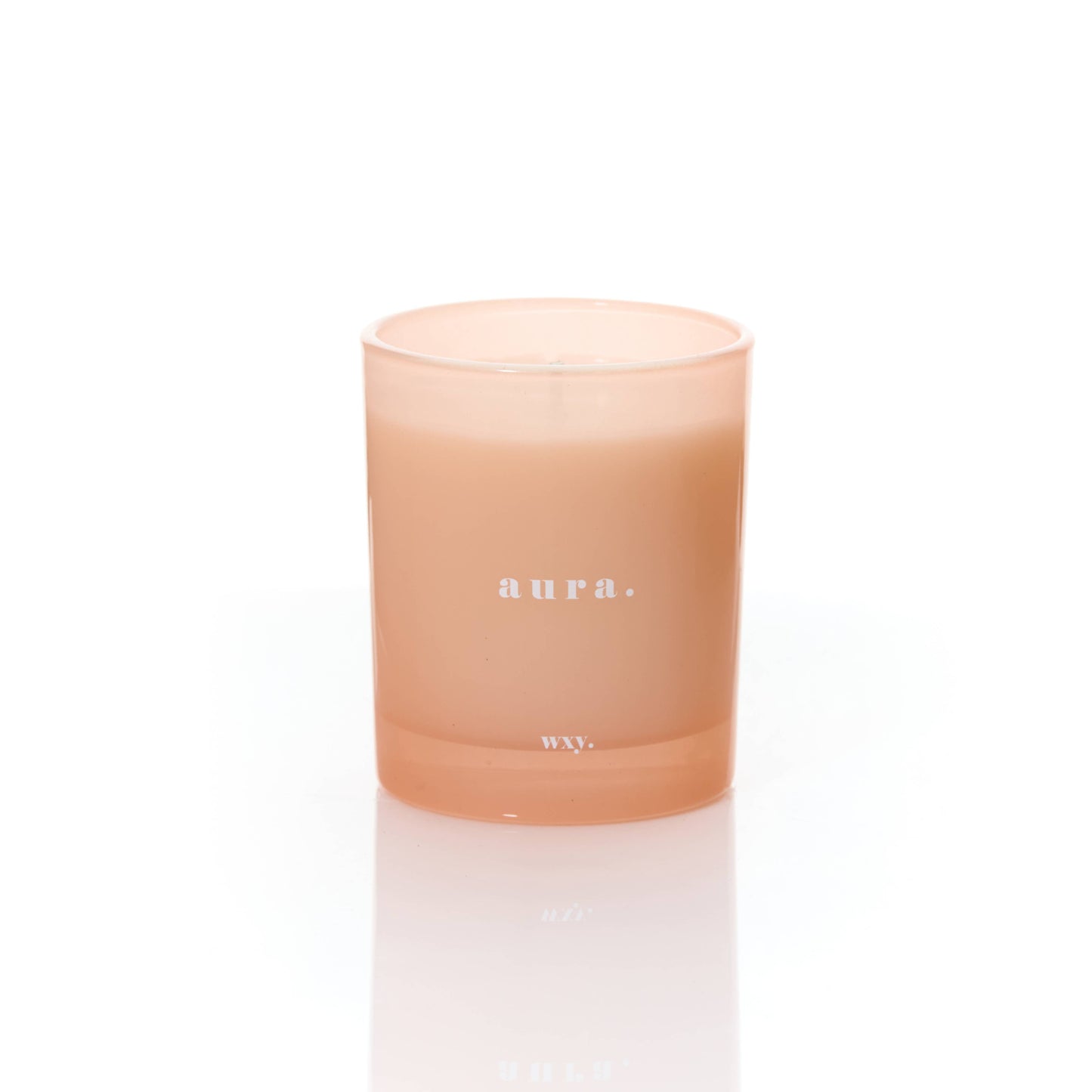 White Woods and Amber Aura 7oz candle by wxy in a sleek glass jar with a lit wick, emitting warm, inviting glow.