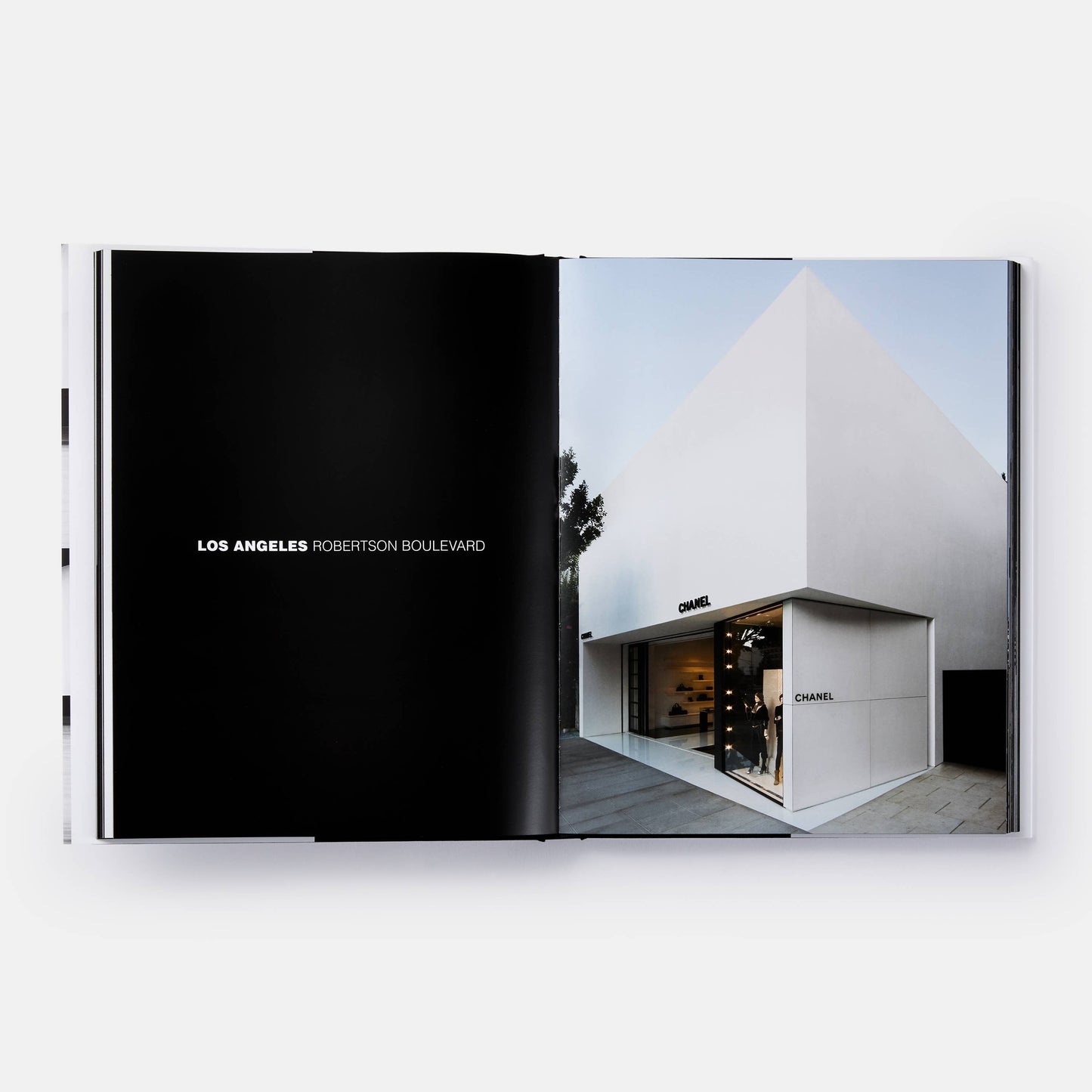 Close-up of the book cover titled "The Architecture of Chanel" by Phaidon, featuring elegant black-and-white Chanel branding.