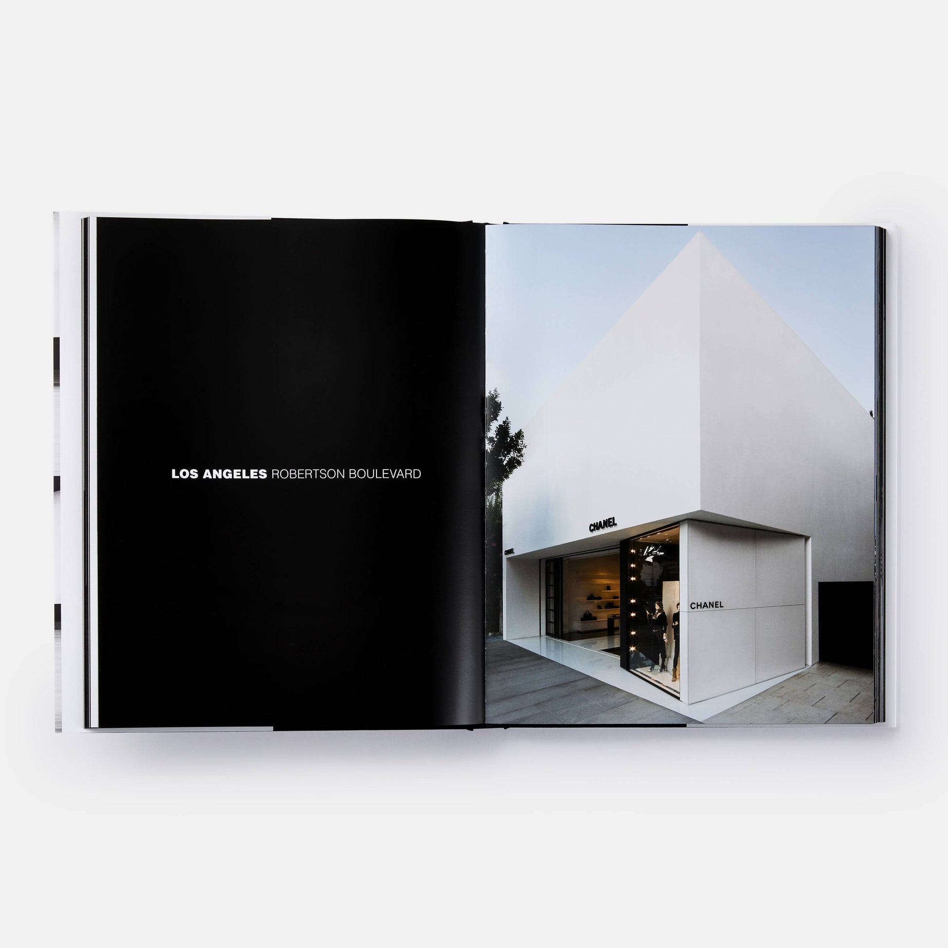 Close-up of the book cover titled "The Architecture of Chanel" by Phaidon, featuring elegant black-and-white Chanel branding.