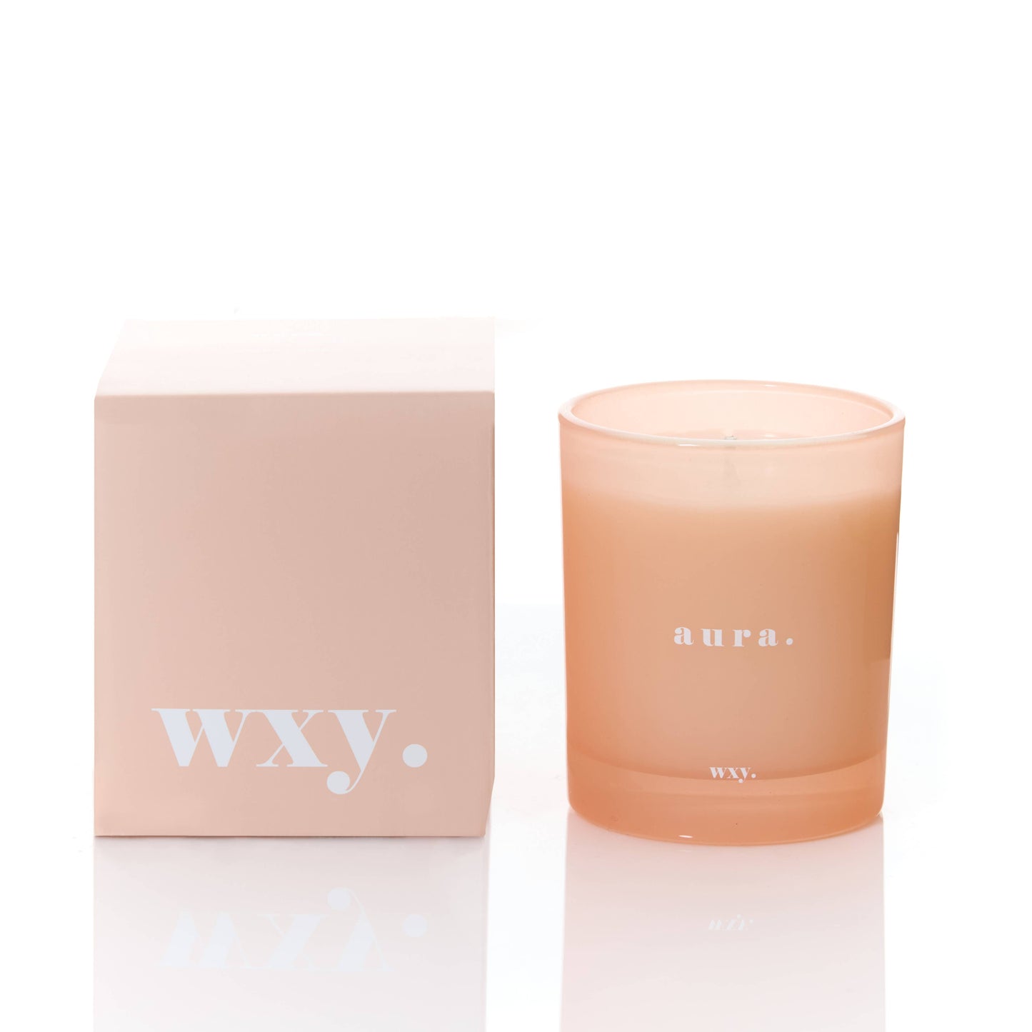 White Wax Aura 7oz candle by wxy with white woods and amber scent, featuring a simple, elegant candle holder.