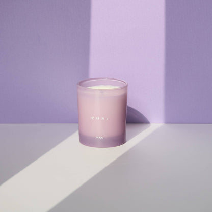 WXY eos 7oz candle with Orris Root and Amber scent, showing a white candle in a glass jar with a decorative label.