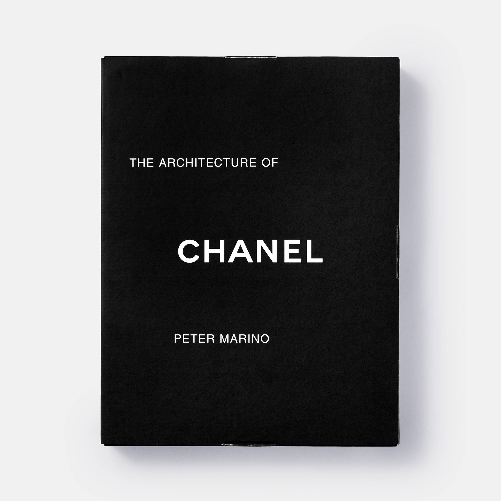Book cover of "The Architecture of Chanel" by Phaidon featuring a Chanel-inspired building design and elegant architectural details.