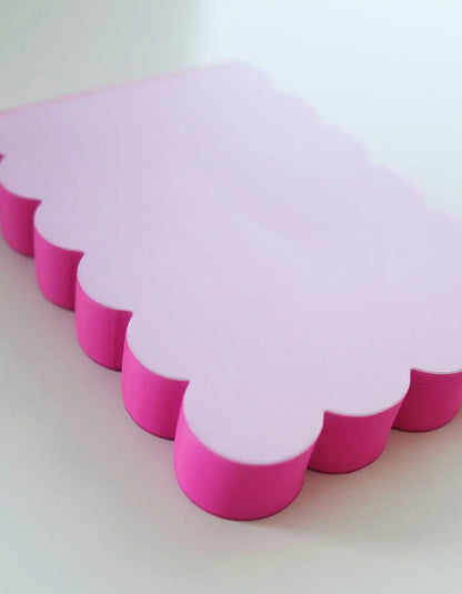 Lilac and hot pink scalloped-shaped notepad from Idlewild Co. with decorative edges, ideal for notes and creative writing.
