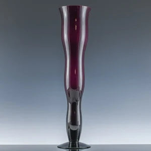 Purple glass wiggle vase by Ozmun Home with a wavy shape and smooth finish, perfect for decorative floral arrangements.