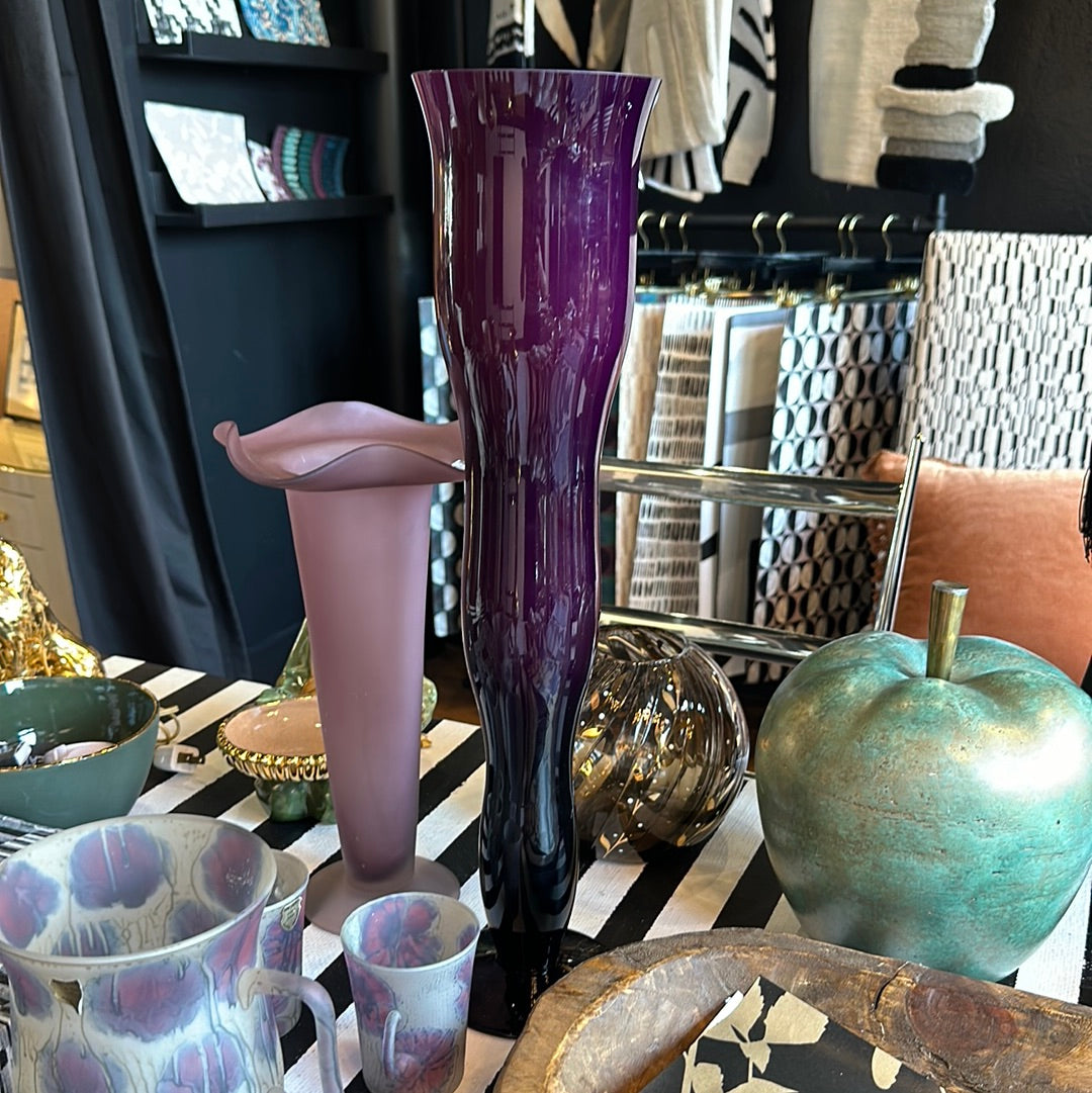 Purple glass wiggle vase by Ozmun Home featuring a unique wavy design and vibrant purple color on a plain background.