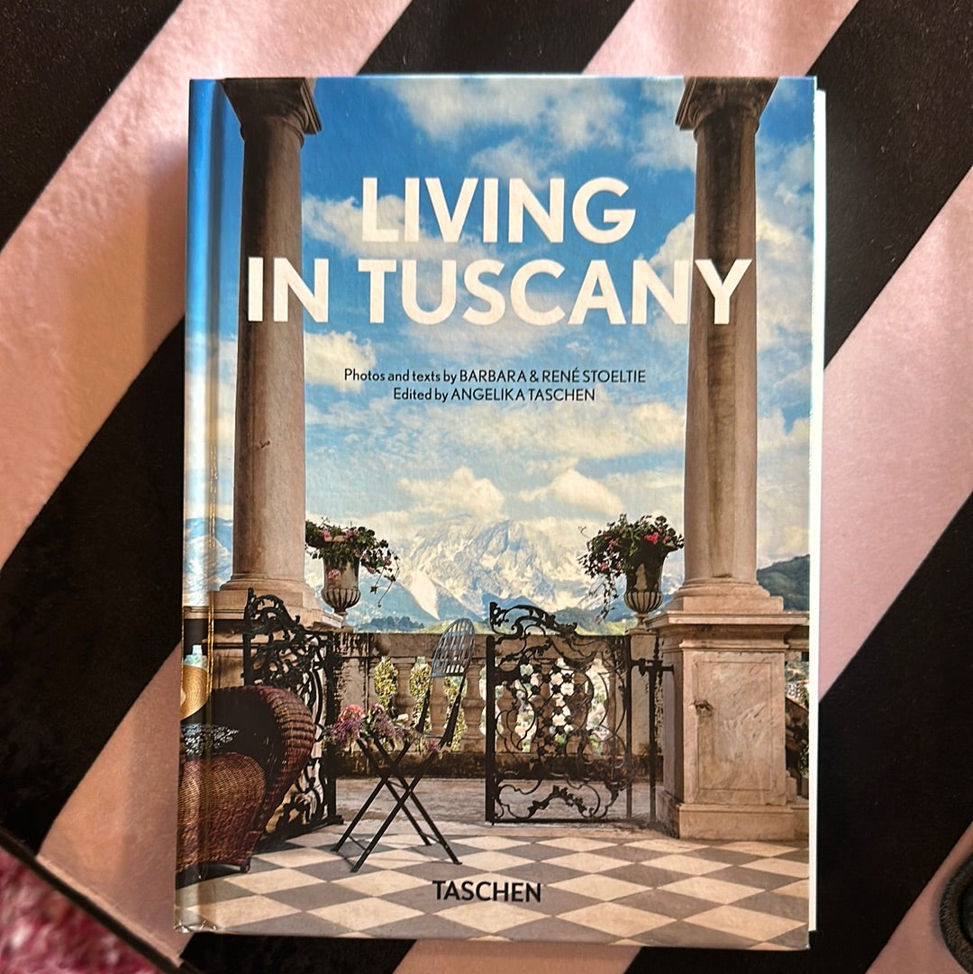 Living in Tuscany 40th edition book by TASCHEN, showcasing scenic Tuscan landscapes and architecture in a high-quality image.